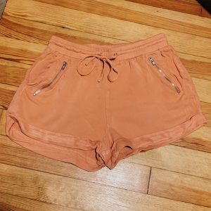 Pink Shorts with Gold Zipper pockets.